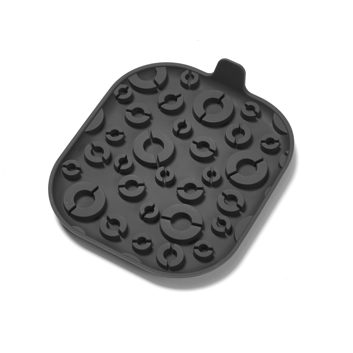 Black silicone lick mat with various shapes on a white background