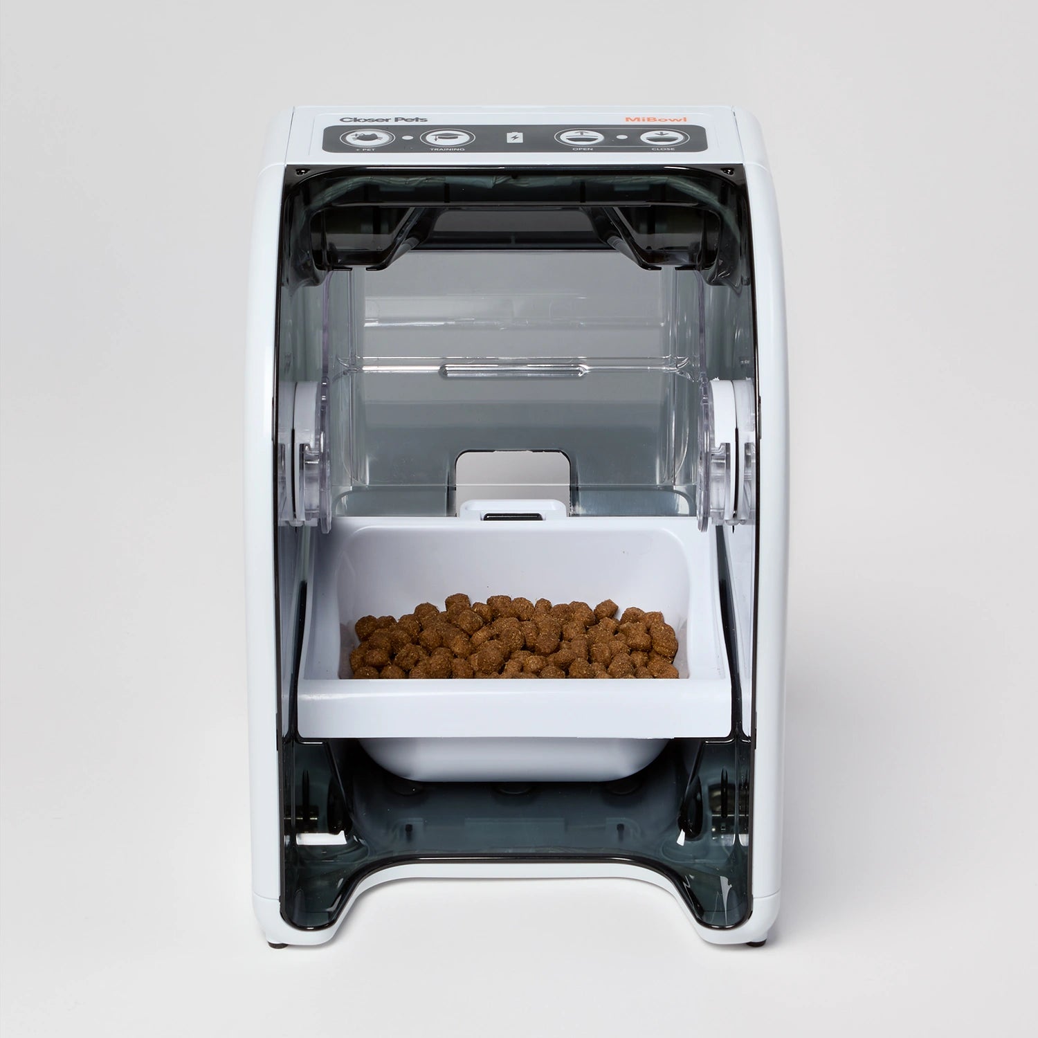 Pet food dispenser with food inside on a white background