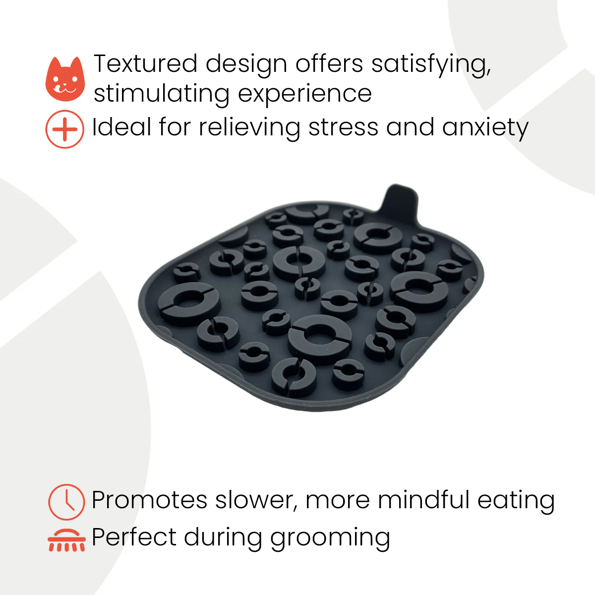 Infographic of a black textured feeding mat with various raised circular patterns and a pull tab. Text highlights its benefits: 'Textured design offers satisfying, stimulating experience,' 'Ideal for relieving stress and anxiety,' 'Promotes slower, more mindful eating,' and 'Perfect during grooming.' Icons accompany each benefit, including a cat face, a plus sign, a clock, and a grooming brush