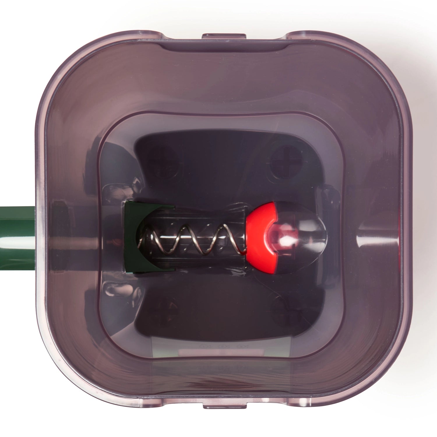 A top-down view of the inside of the automatic feeder for pond fish in green, against a white background. 