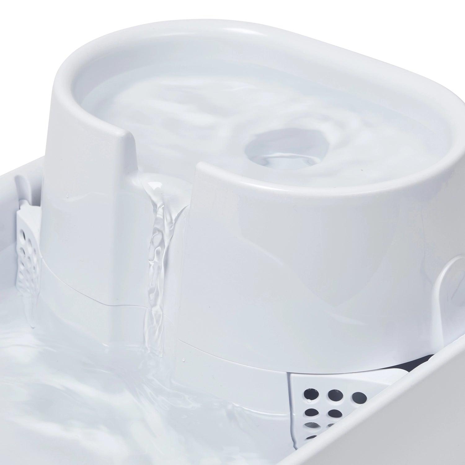Close-up of water flowing down the fountain on a white background