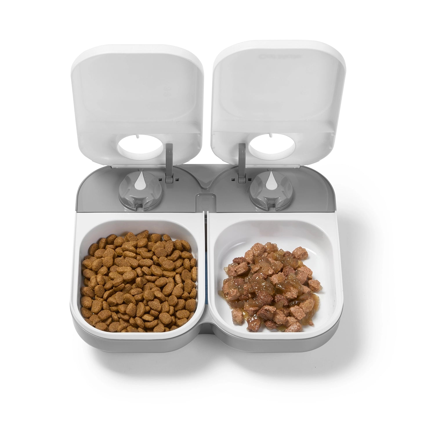Pet food dispenser with two compartments filled with kibble on a white background